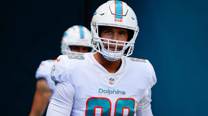 Dolphins tight end Mike Gesicki walks onto the field before a game.